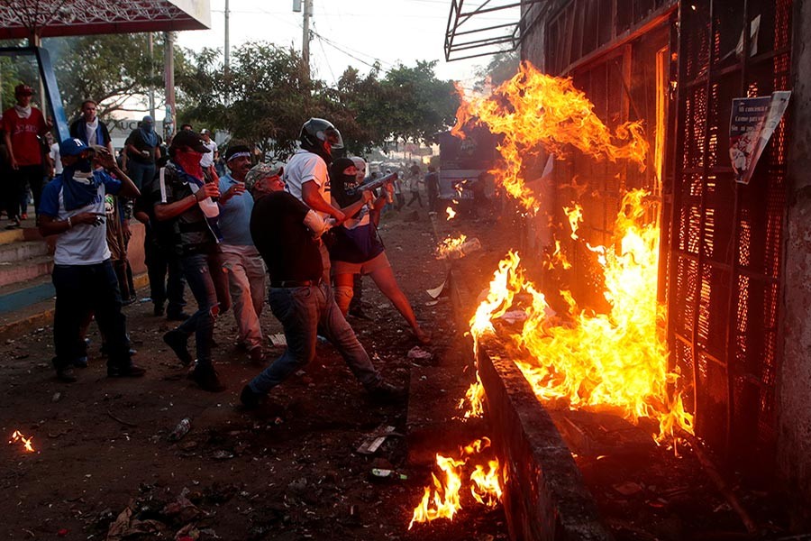 Demonstrators burn the Sandinista radio station during clashes with riot police during a protest against President Daniel Ortega's government in Managua on Wednesday - Reuters photo