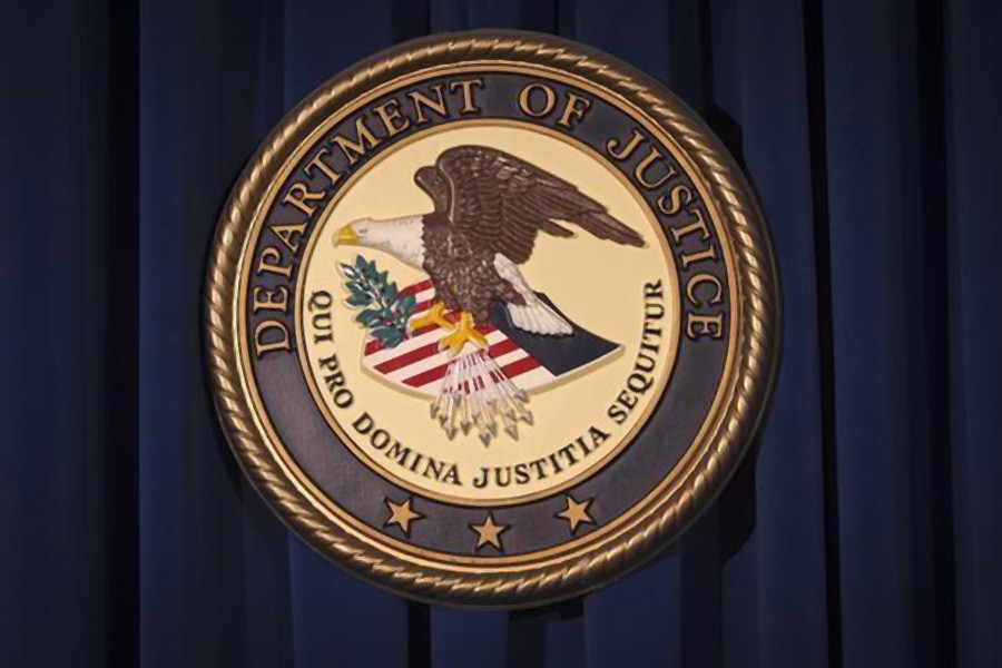 The Department of Justice (DOJ) logo is pictured on a wall after a news conference in New York December 5, 2013. Reuters.