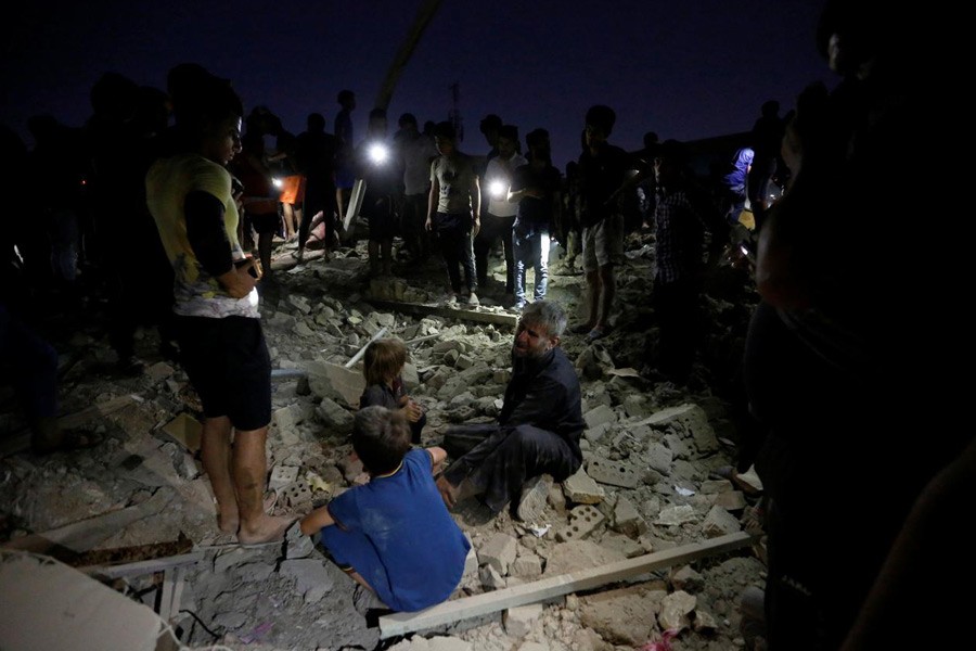 People react at the site of a car bomb attack in Sadr City district of Baghdad, Iraq June 6, 2018. Reuters.