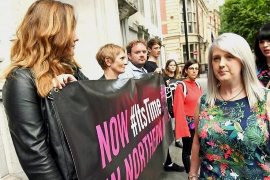 Human rights campaigners held banners at the Supreme Court in London on Thursday morning. Photo: PA