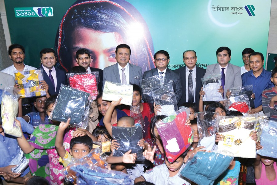 Advisor of Premier Bank Limited Muhammed Ali, Managing Director & CEO M. Reazul Karim seen along with underprivileged children at 'Eid Anondo Hok Shobar' campaign at the bank's head office recently