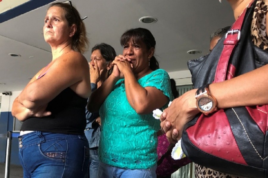 Relatives of people who died at Los Cotorros club when a person activated a tear gas grenade inside, according to Venezuela's interior minister Nestor Reverol, react outside the Perez Carreno hospital in Caracas, Venezuela, June 16, 2018. Reuters