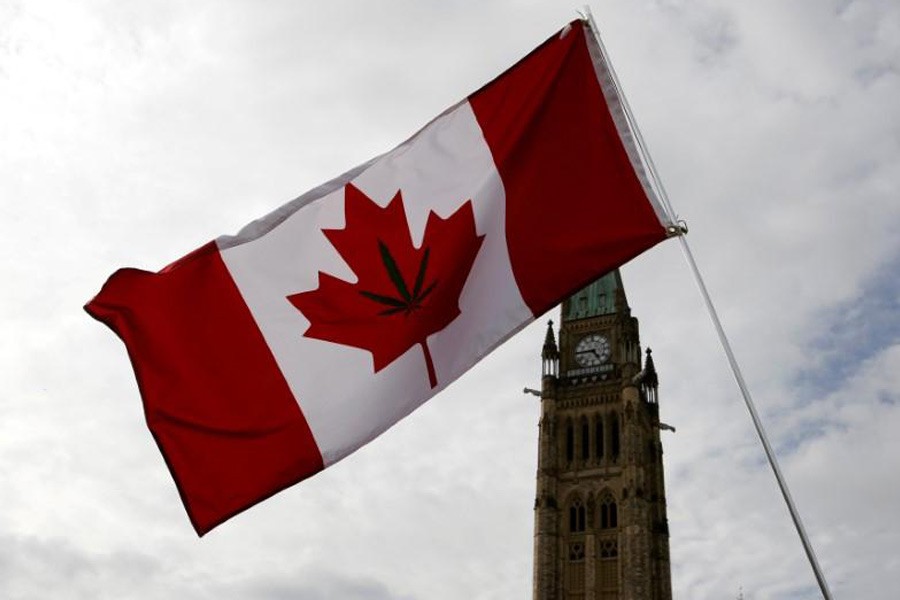 A Canadian flag with a marijuana leaf on it is seen during the annual 4/20 marijuana rally on Parliament Hill in Ottawa, Ontario, Canada, April 20, 2017. Reuters.