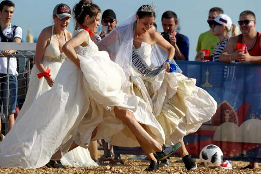 Women wearing wedding dresses take part in the so-called "brides' match" at the FIFA Fan Fest in Kazan, a host city for the 2018 FIFA World Cup, Russia, June 30, 2018. Reuters/