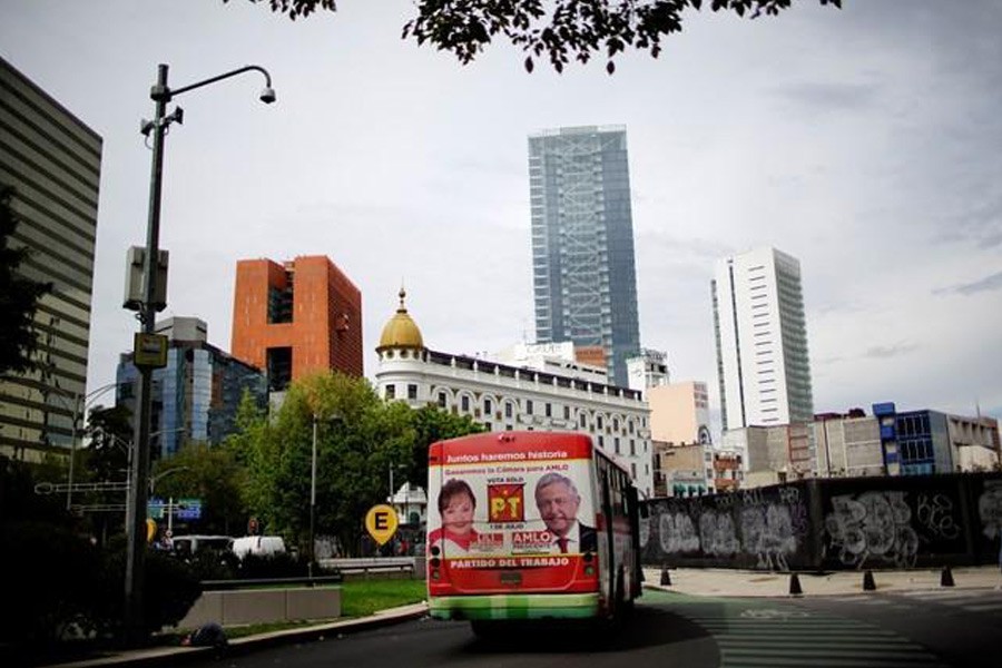 An image of Mexico's presidential election front-runner Andres Manuel Lopez Obrador, of the National Regeneration Movement - MORENA (R), is displayed on a public bus in Mexico City, June 22, 2018. Reuters file photo.