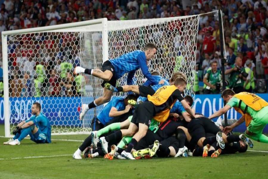 Football - World Cup - Quarter Final - Russia vs Croatia - Fisht Stadium, Sochi, Russia - July 7, 2018 Croatia's Domagoj Vida, Dejan Lovren and Josip Pivaric celebrate after winning the penalty shootout. Reuters