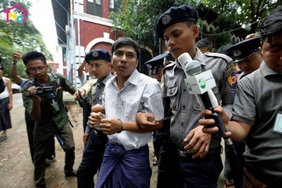 Detained Reuters journalist Kyaw Soe Oo is escorted by police while leaving Insein court in Yangon, Myanmar on Monday last - Reuters photo