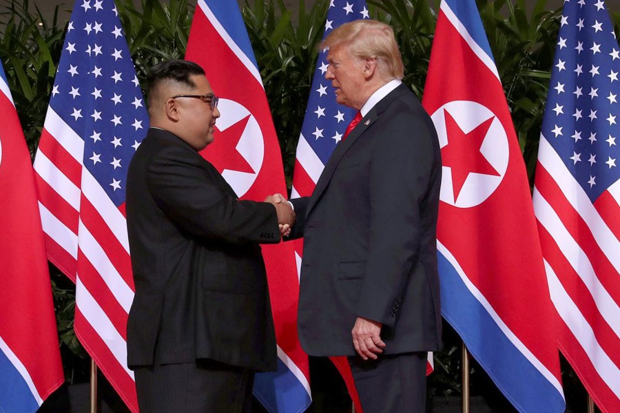 US President Donald Trump shakes hands with North Korean leader Kim Jong Un at the Capella Hotel on Sentosa island in Singapore June 12, 2018 – Reuters