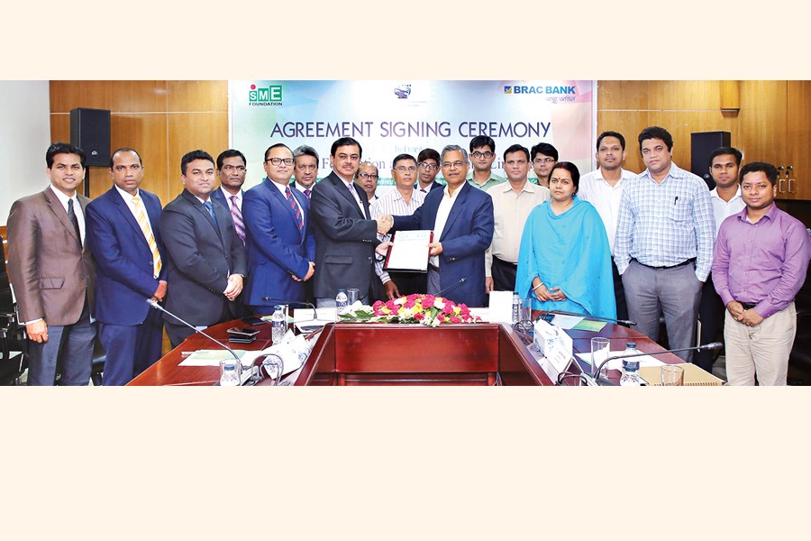 Managing Director and CEO of BRAC Bank Selim R. F. Hussain (left) and Managing Director of SME Foundation Md. Safiqul Islam (right) exchanging documents after signing an agreement at SME Foundation office in the capital on Wednesday