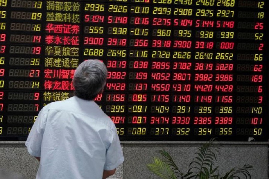 A man looks at an electronic board showing stock information at a brokerage house in Shanghai, China July 6, 2018. Reuters