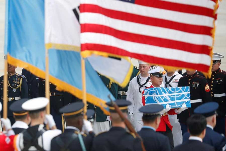 A soldier carries a casket containing the remains of a US soldier who was killed in the Korean War during a ceremony at Osan Air Base in Pyeongtaek, South Korea, July 27, 2018. Reuters