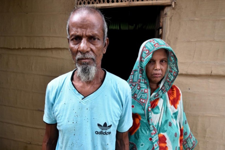 Abdul Suban, a farmer, and his wife pose for a photograph outside their home in Nellie village, in Morigaon district, in the northeastern state of Assam, India July 25, 2018. Reuters/Files