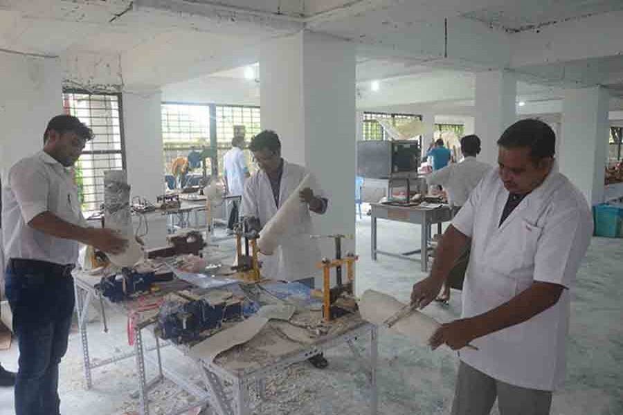 Technicians assembling artificial limbs, manufactured under the India-Myanmar Development Cooperation programme, for people with disabilities in Yangon. Photo: Collected