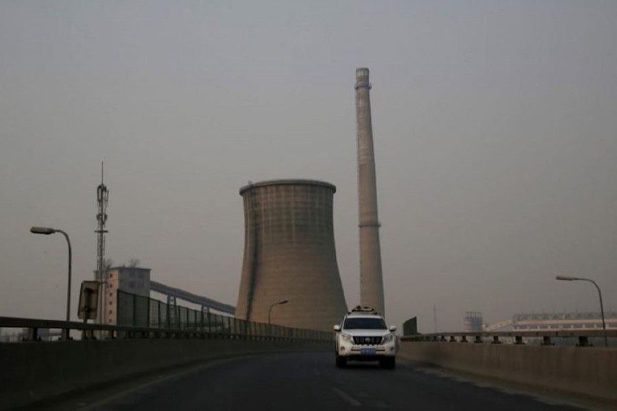 A vehicle drives past a closed factory on a polluted day after the Chinese Lunar New Year holidays in Beijing, China, onFebruary 3, 2017 — Reuters/File