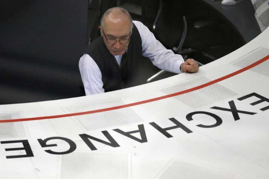 An employee of the Tokyo Stock Exchange (TSE) works at the bourse in Tokyo, Japan, February 6, 2018. Reuters/File Photo