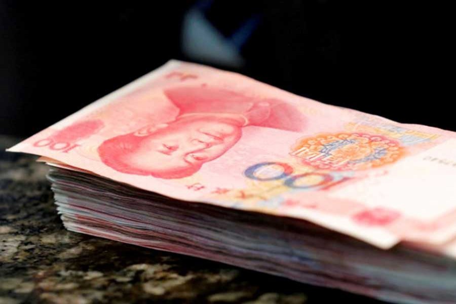 Chinese 100 yuan banknotes are seen on a counter of a branch of a commercial bank in Beijing, China, March 30, 2016. Reuters/File Photo