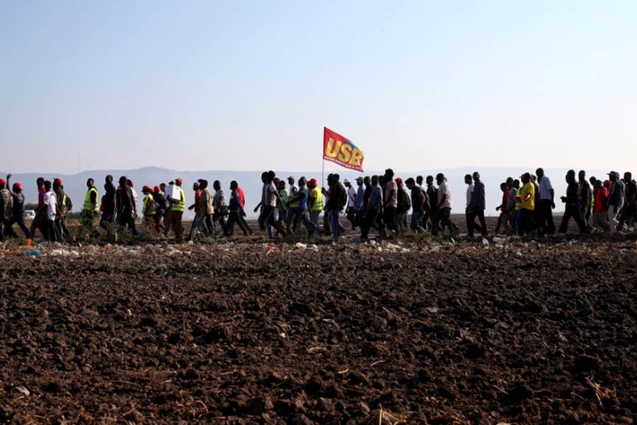 African migrant labourers staging a march to protest against their work conditions in Italy, following the death of 16 of their colleagues in two separate road accidents. -Reuters Photo