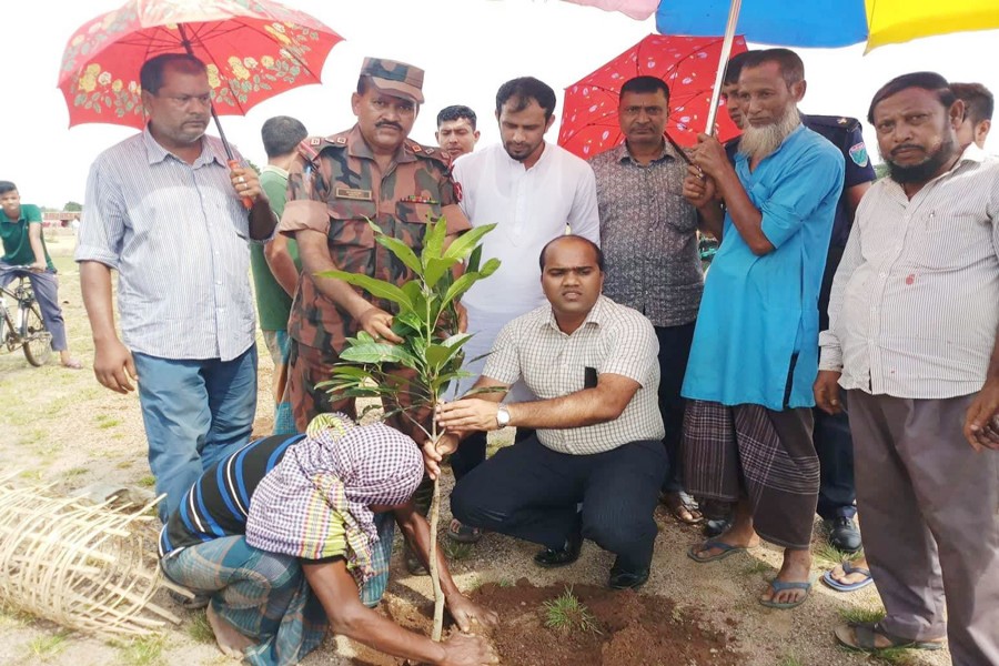 Gowainghat UNO planting a sapling in the area of the proposed eco-park in Bisnakandi of Sylhet on Wednesday  	— FE Photo