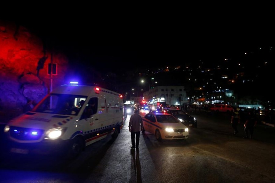 An ambulance and a Jordanian police car is seen one day after the security incident, at the city of Al Salt, Jordan on Saturday — Reuters