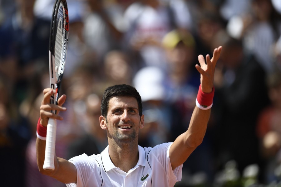 Djokovic overcomes illness, opponent to progress in Cincinnati