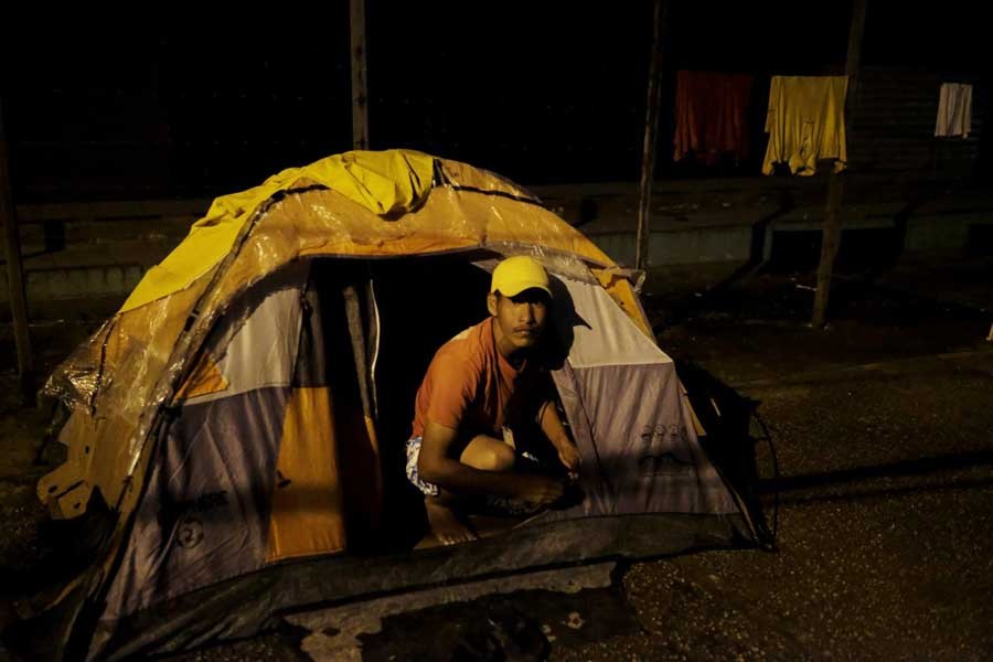 Venezuelan man is pictured at the entrance of his, tent set up along the street, as he waits to show his passport or identity card next day at the Pacaraima border control, Roraima state, Brazil August 8, 2018. Reuters