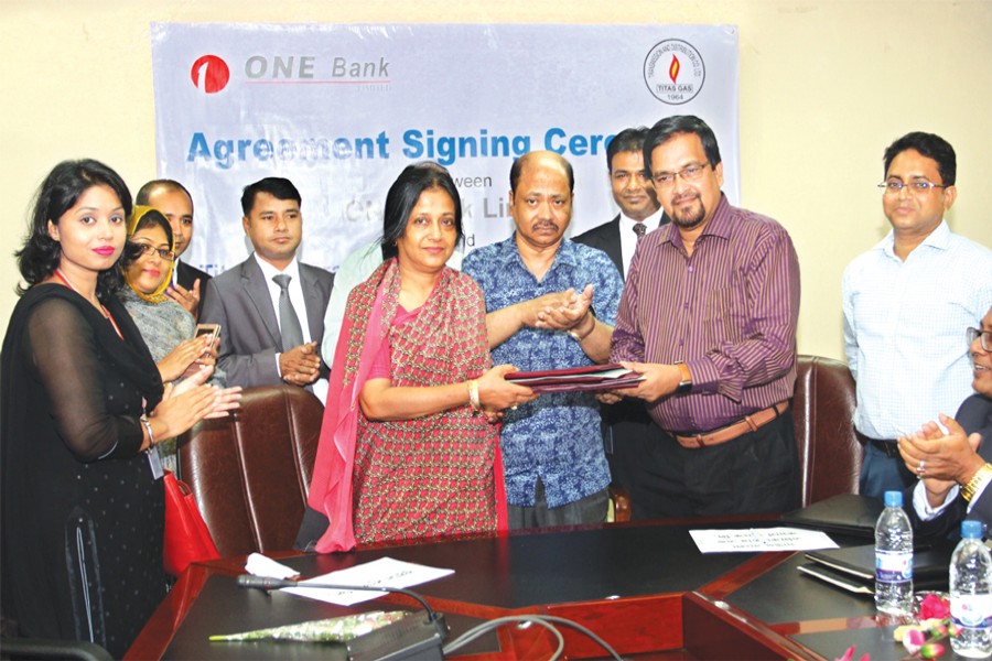 Additional Deputy Managing Director of ONE Bank Limited Rozina Aliya Ahmed and General Manager-Administration and Company Secretary (additional charge) of Titas Gas Transmission and Distribution Company Limited Mahmudur Rab exchanging documents after signing an agreement on behalf of their respective organisations recently