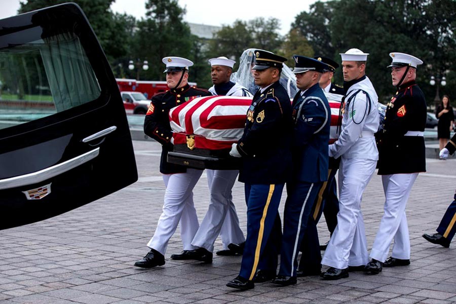 Joint service members of a military casket team carrying the casket of Senator John McCain for a motorcade that will ferry him to a funeral service at the National Cathedral in Washington on Saturday. -Reuters Photo