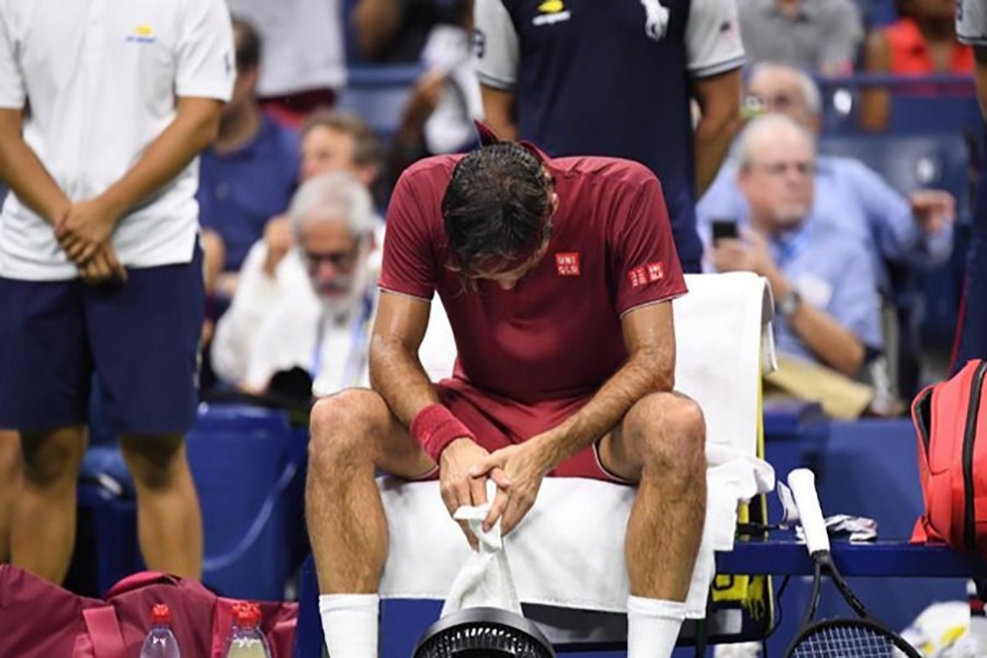 Roger Federer of Switzerland cuts a dejected figure during a changeover in a fourth round match against John Millman of Australia on day eight of the 2018 US Open tennis tournament on Monday — USA Today Sports photo via Reuters