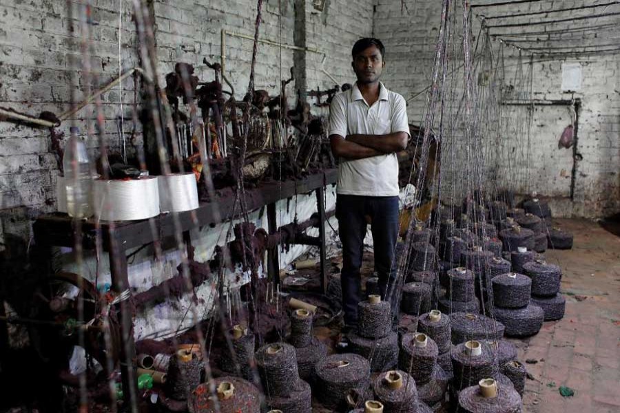 Tilak Raj Bathla, 50, owner of a weaving factory, poses for a picture at a closed section of his factory, in Panipat in Haryana, India, August 29, 2018. Reuters