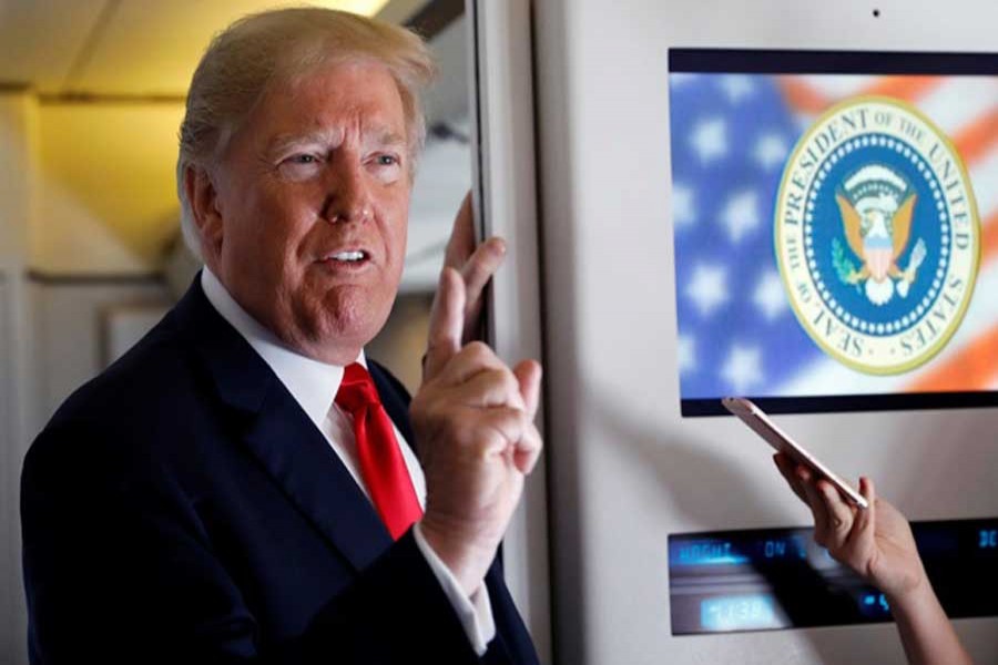 US President Donald Trump speaks to reporters aboard Air Force One on his way to Fargo, North Dakota, US, September 7, 2018. Reuters