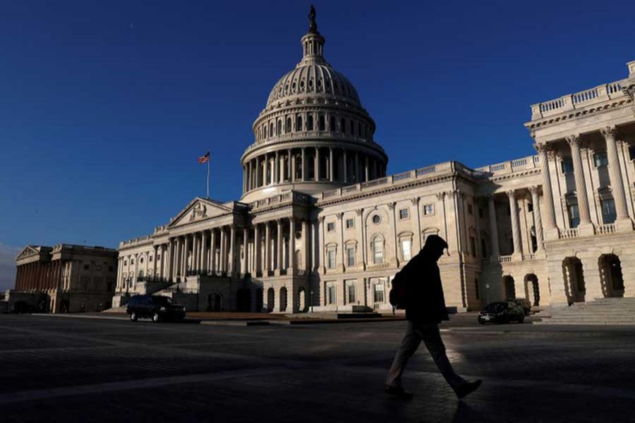 People walk by the US Capitol building in Washington, US, February 8, 2018. Reuters/Files