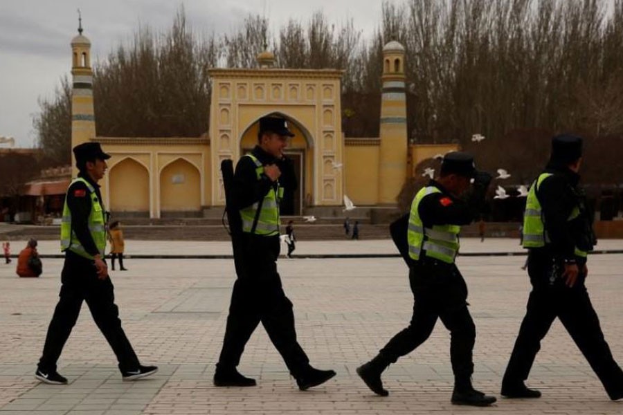 A police patrol walk in front of the Id Kah Mosque in the old city of Kashgar, Xinjiang Uighur Autonomous Region, China, March 22, 2017 – Reuters file photo