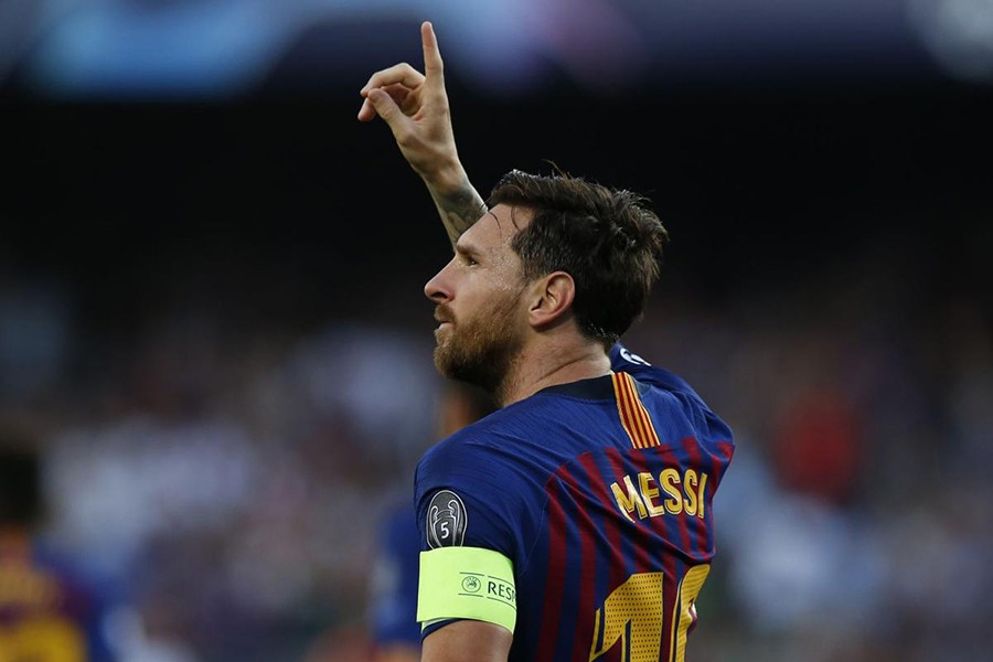 Barcelona forward Lionel Messi celebrates after scoring the opening goal of his team during the group B Champions League match between FC Barcelona and PSV Eindhoven at the Camp Nou stadium on Tuesday — AP photo