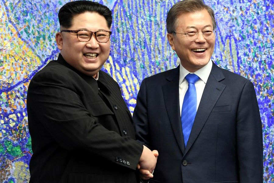 South Korean President Moon Jae-in shakes hands with North Korean leader Kim Jong Un during their meeting at the Peace House - Korea Summit Press Pool/Pool via Reuters