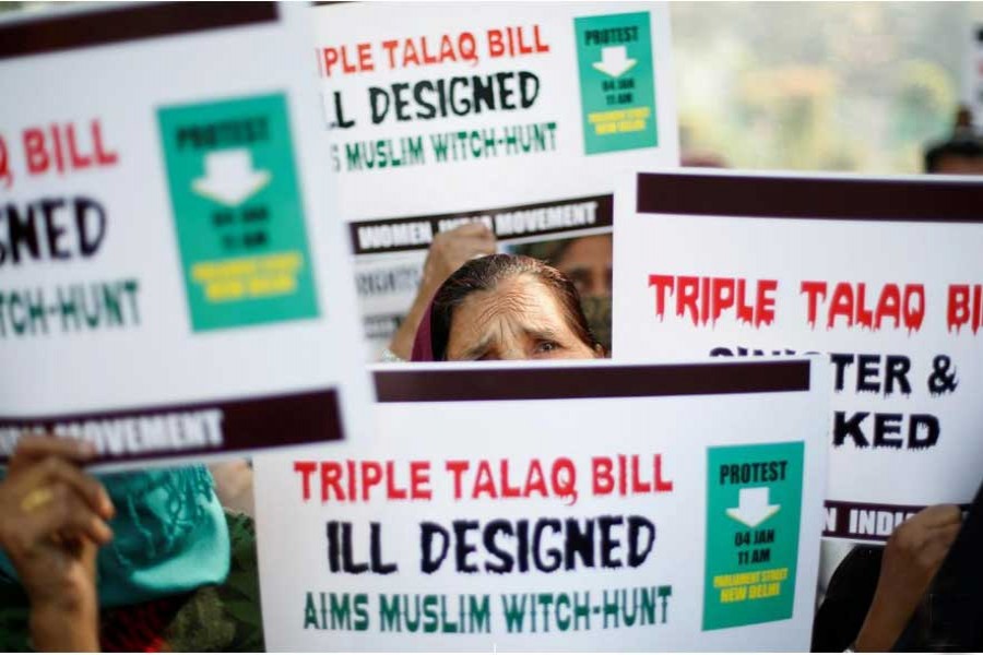 Muslim women hold placards during a protest against a bill passed by India's lower house of Parliament last week that aims at prosecuting Muslim men who divorce their wives through the "triple talaq," or instant divorce, in New Delhi, India Jan 4, 2018.  - Reuters