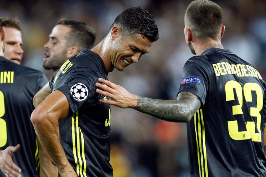 Juventus forward Cristiano Ronaldo is consoled by teammate Federico Bernardeschi, right, after receiving a red card during the Champions League, group H soccer match between Valencia and Juventus, at the Mestalla stadium in Valencia, Spain, Wednesday, Sept 19, 2018 - AP