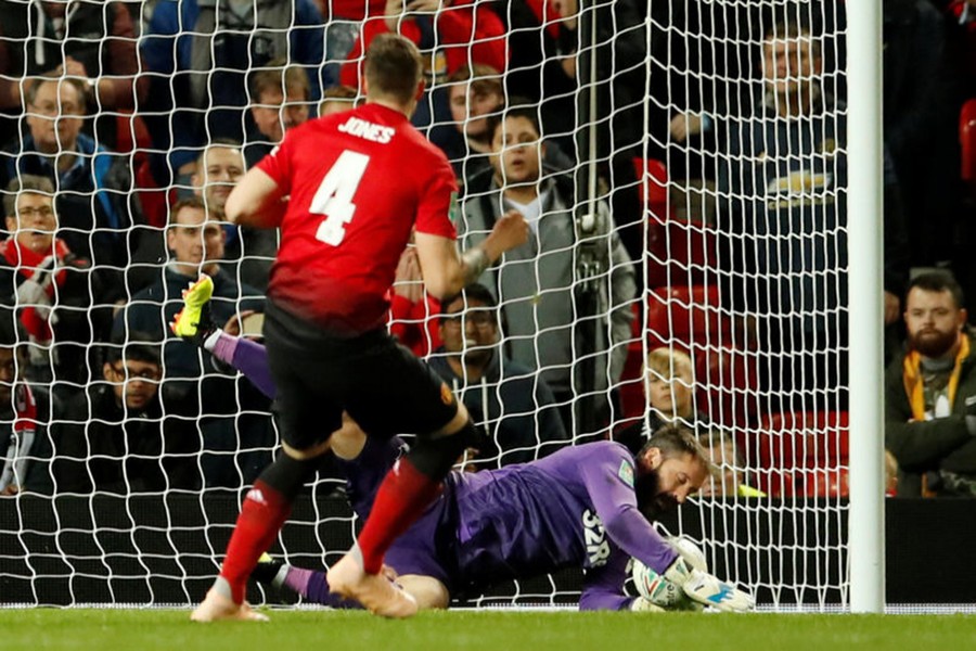 Manchester United's Phil Jones has a penalty saved by Derby County's Scott Carson during the shootout — Reuters action image