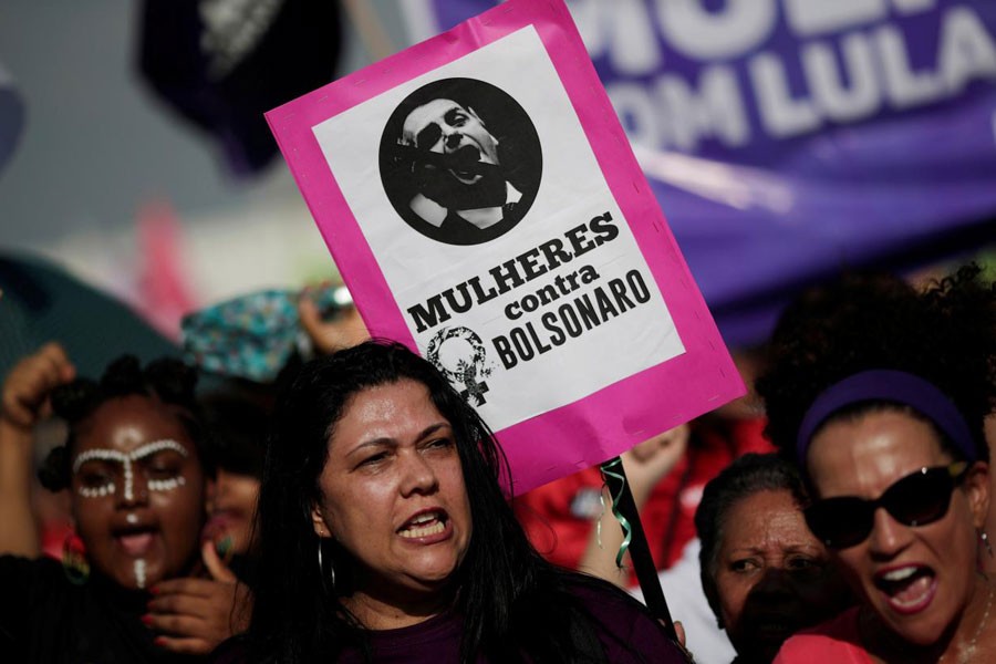 A woman holds a sign that reads "Women against Bolsonaro" during demonstrations against presidential candidate Jair Bolsonaro in Brasilia, Brazil September 29, 2018 – Reuters