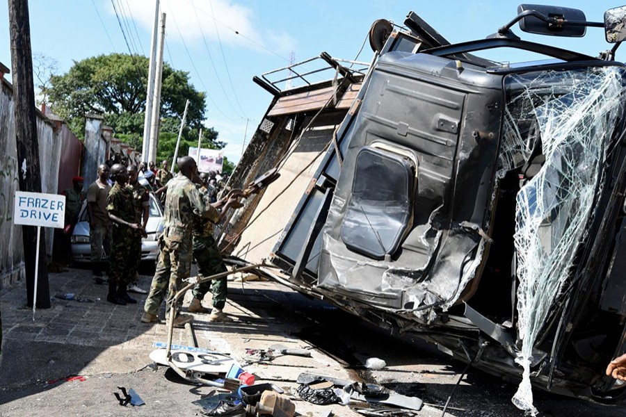 Rescue workers are seen near an overturned military vehicle after a collision in Freetown, Sierra Leone on Monday — Reuters photo