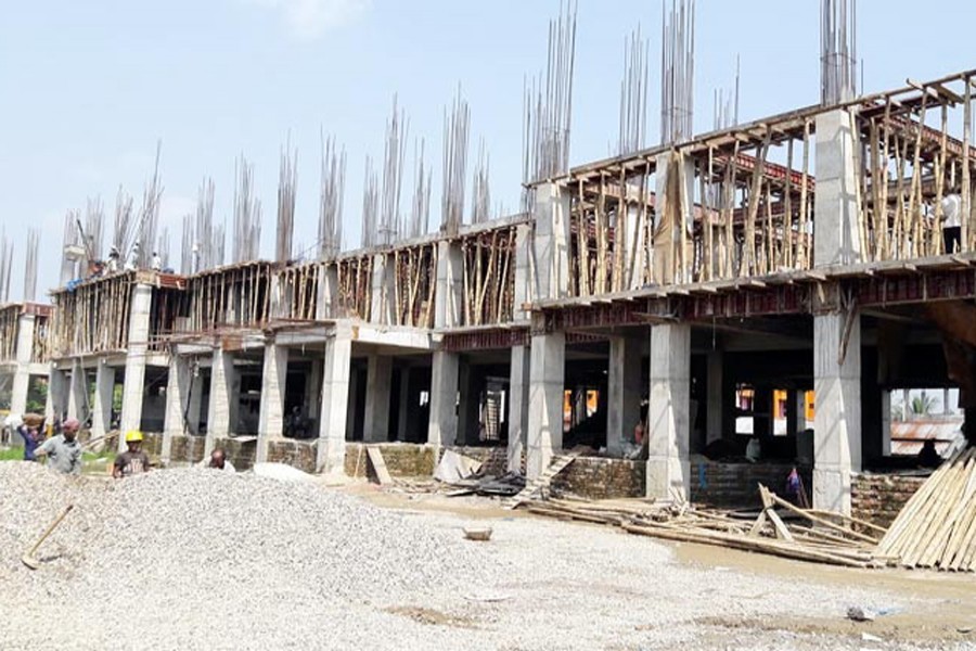 Labourers working at the construction site of the 10-storey building for the Chief Judicial Magistrate Court in Sunamganj on Sunday   	—  FE Photo