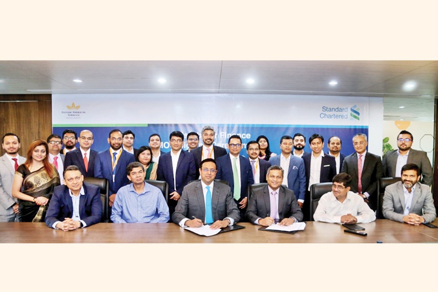 Shehzad Munim, Managing Director of British American Tobacco Bangladesh (BAT Bangladesh), and Naser Ezaz Bijoy, CEO, Standard Chartered Bangladesh signing an MoU on behalf of their respective companies at BAT head office in the city recently