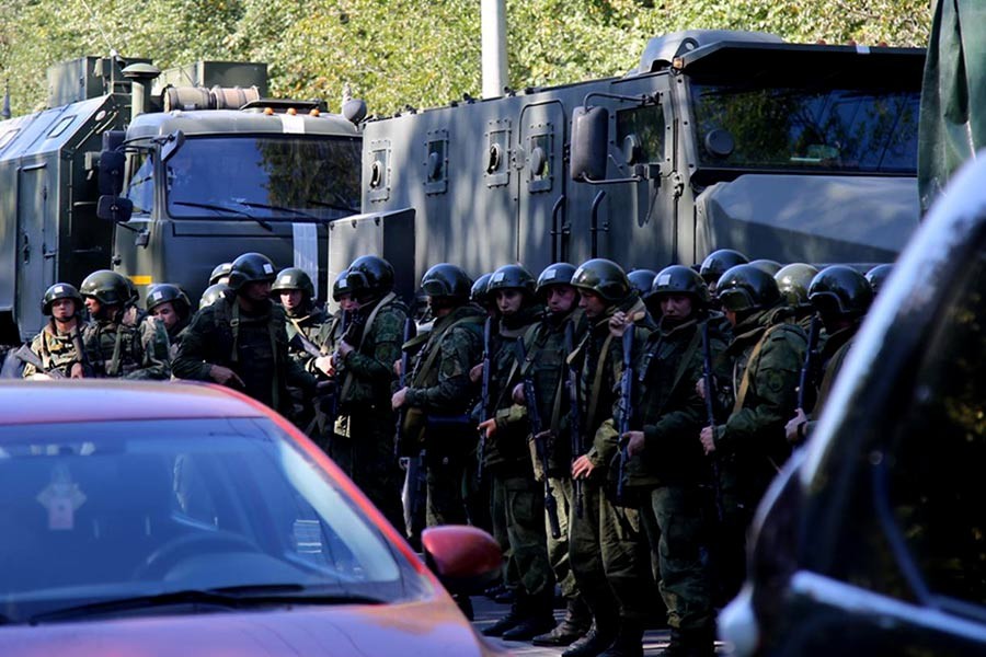 Law enforcement officers standing in line at the scene of a fatal attack on a college in the port city of Kerch in Crimea on Wednesday. -Reuters Photo