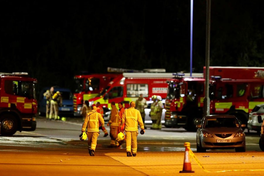 Soccer Football - Premier League - Leicester City v West Ham United - King Power Stadium, Leicester, Britain - October 27, 2018 Firefighters at the scene of where the helicopter belonging to Leicester City owner Vichai Srivaddhanaprabha crashed outside the King Power Stadium Action Images via Reuters/Jason Cairnduff