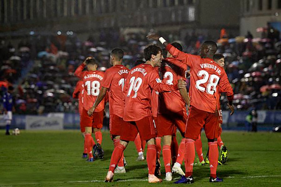 Real Madrid's Alvaro Odriozola (L) celebrates with his teammates after scoring in the clash against Melilla at the Municipal Alvarez Claro stadium in the Spain's enclave of Melilla on Wednesday — AP photo