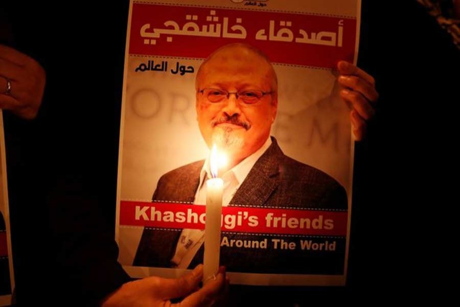 A demonstrator holds a poster with a picture of Saudi journalist Jamal Khashoggi outside the Saudi Arabia consulate in Istanbul, Turkey October 25, 2018. Reuters