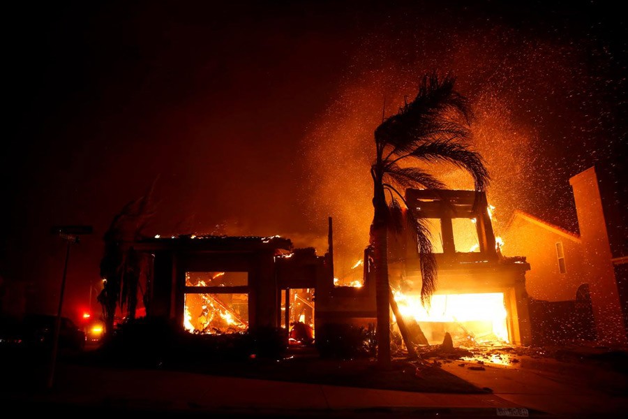 A home burns during a wildfire that claimed dozens of homes in Thousand Oaks, California, US, November 9, 2018 - Reuters/Eric Thayer/File Photo