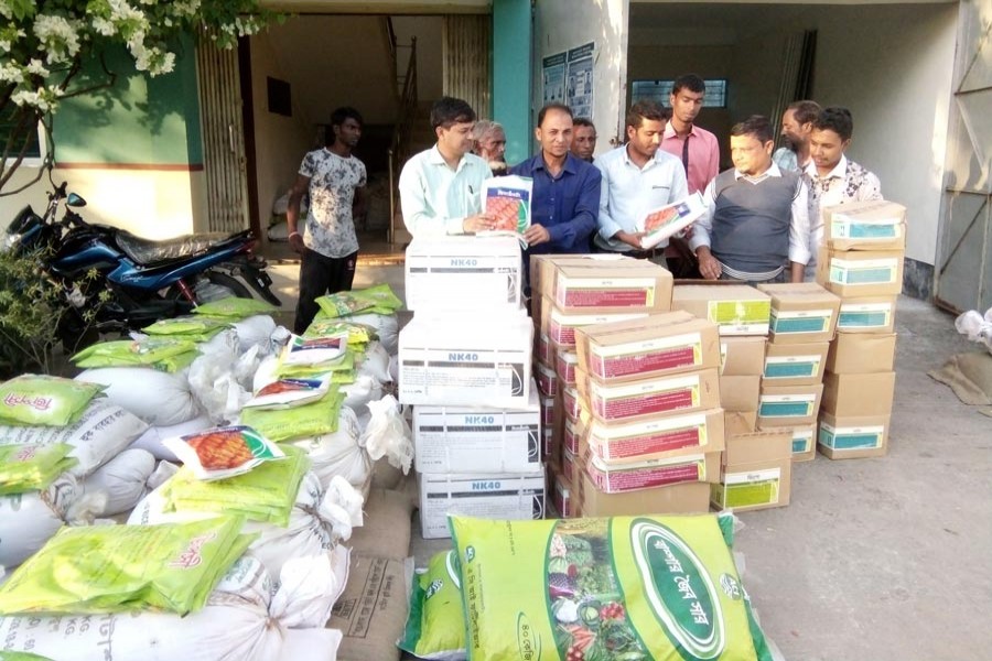 DAE officials distributing hybrid maize seeds and fertilisers among the listed farmers of Golapganj upazila in Sylhet recently 	— FE Photo