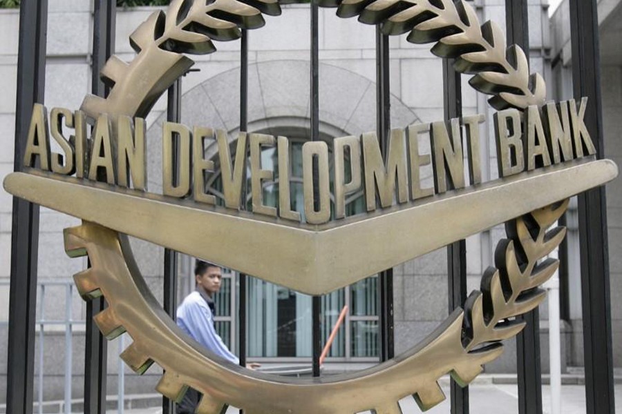 A worker walks past inside the Asian Development Bank (ADB) headquarters in Manila, June 17, 2009. Reuters/Files