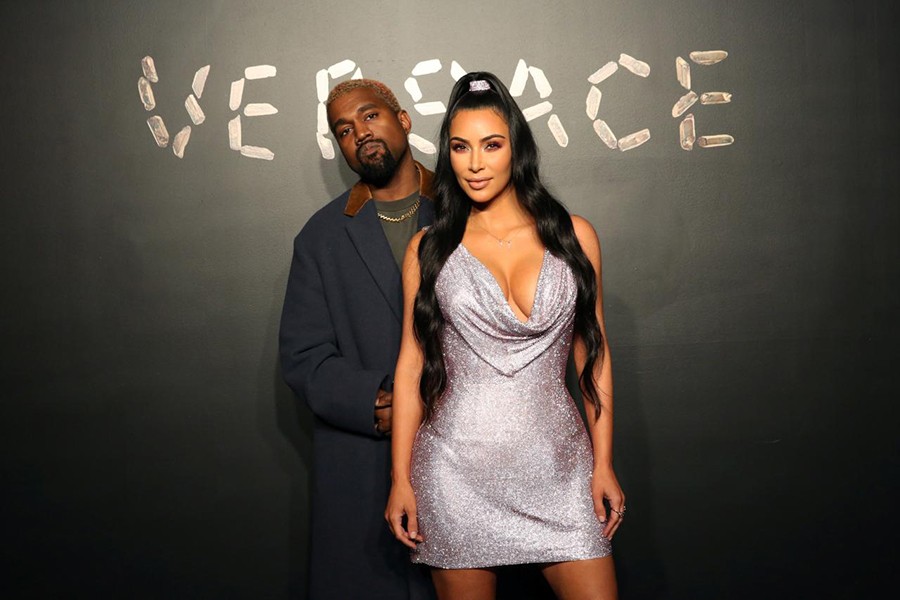 Kanye West and Kim Kardashian pose for a photo before attending the Versace presentation in New York, US December 2, 2018. Reuters/File