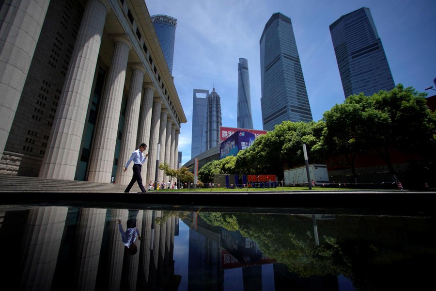 A man walks at Lujiazui financial district of Pudong in Shanghai, China, July 17, 2017. Reuters/Files